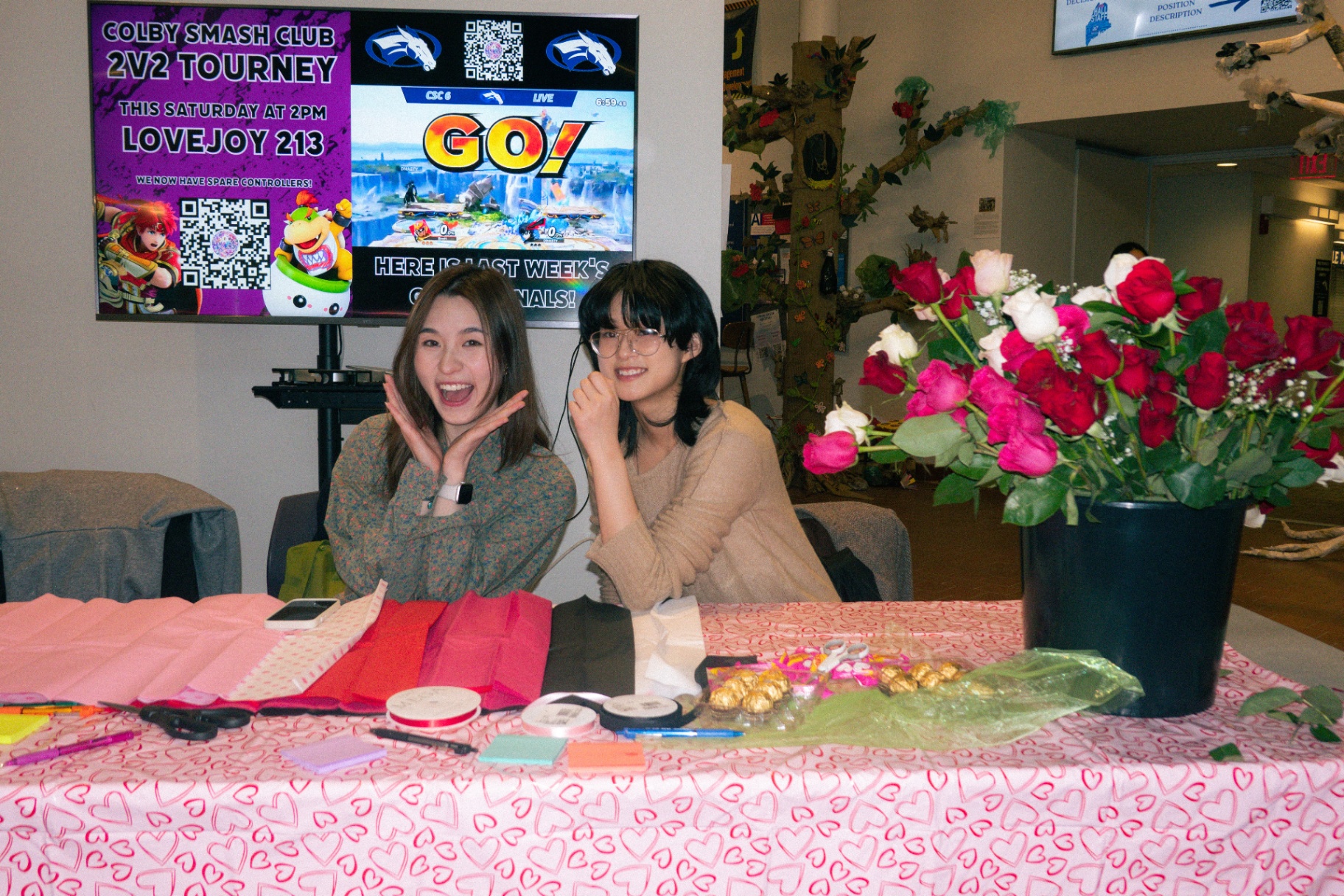 Behind the table — The giveaway in full swing — roses, ribbon, hearts