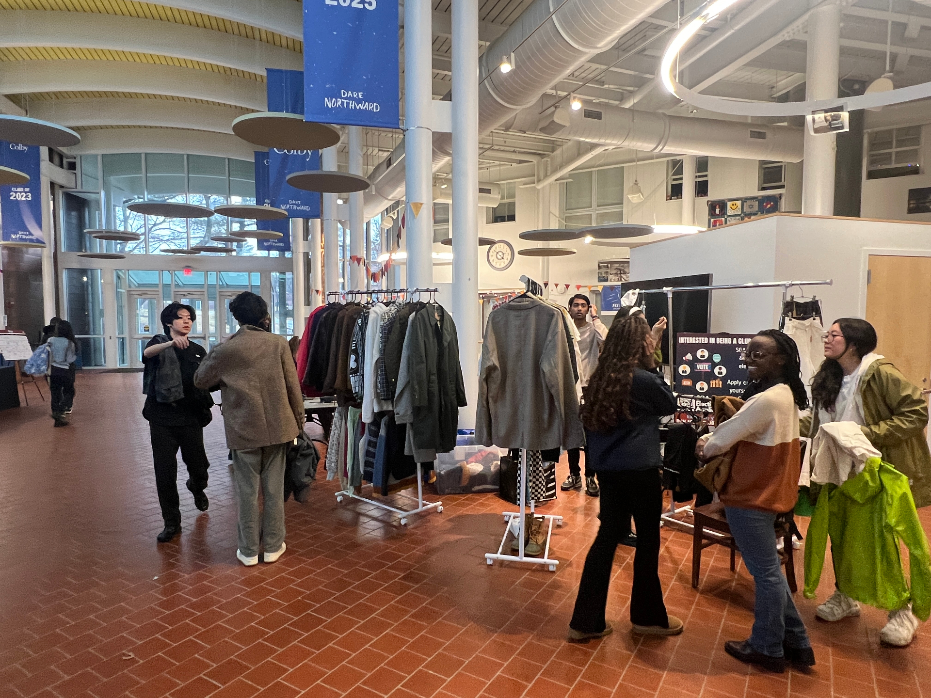 Racks in the hall — Year-end thrift I organized — Colby Pulver atrium