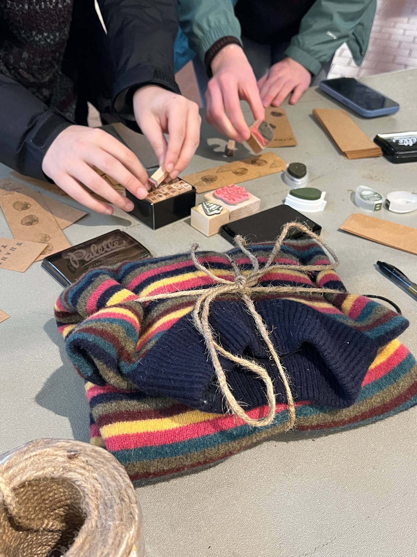 Stamped and tied — Hand-wrapped sweater, kraft tag, jute twine